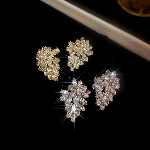 Sparkling leaf-shaped diamond studs in gold and silver finish with crystal clusters