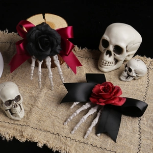 Halloween skeletal hand hair clips with gothic roses and ribbons on rustic burlap