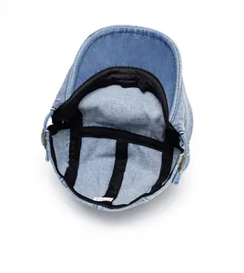 Internal structure of denim flat cap showing sweatband and adjustable metal buckle