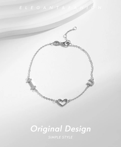 Detail of silver S925 heart bracelet with crystal I and U letter charms and lobster clasp