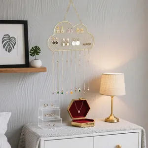 Cloud-shaped gold metal wall organizer for hanging earrings and necklaces on mesh grid