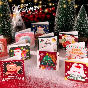 Set of mini Christmas greeting cards with Santa and tree motifs in festive snow scene