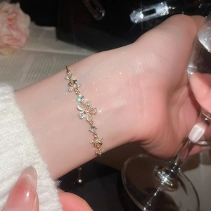 Macro view of gold plated butterfly bracelet with shimmering zircons and opal stone