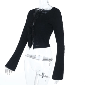 Detailed close-up of black ribbed knit crop top featuring adjustable lace-up tie design