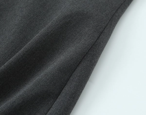 Detailed macro view of dark grey fabric texture for casual mini dress material