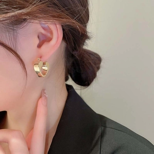 Polished gold hollow heart-shaped stud earrings in minimalist 3D geometric style