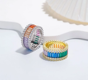 Macro shot of silver and gold rainbow rings with colorful rectangular gemstones