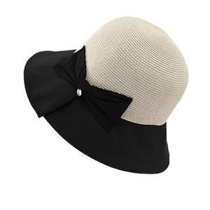 Women's foldable sun hat with beige straw crown and black fabric brim and bow