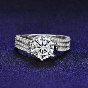 Macro shot of silver ring with six-prong moissanite stone and twisted diamond band