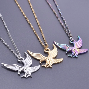 Detailed view of three stainless steel eagle pendant necklaces in gold, silver and rainbow colors
