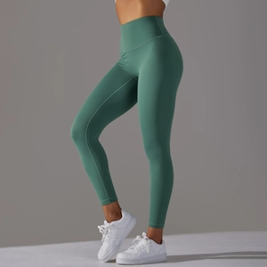 Detail showing high-waist yoga pants in sage green with seamless skin-friendly fabric