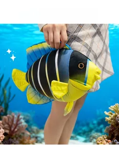 Macro shot of tropical fish plush toy with yellow and blue stripes in underwater scene