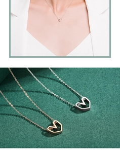 Detail of hollow heart pendants in gold and silver finish with elegant link chain