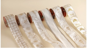 Detail of champagne Christmas ribbons featuring glitter snowflakes and festive patterns