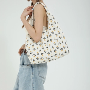 Large capacity corduroy tote bag with yellow tulip print shown in a side-view carry