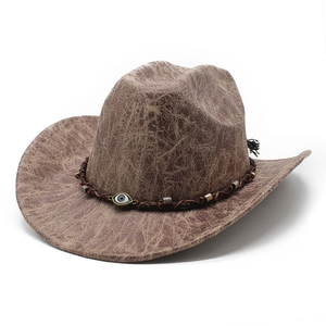 Dettaglio di un cappello da cowboy in camoscio marrone con occhio turco e fascia intrecciata