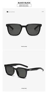 Detailed view of black sunglasses with silver star hardware and dark grey lenses
