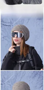Close-up of thick grey knit beanie with leather patch and winter skiing gear detail
