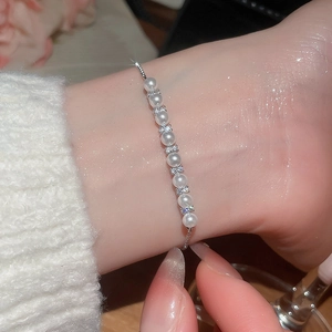 Close-up of pearl bracelet with cubic zirconia spacers and adjustable bolo clasp