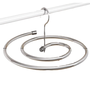 Spiral stainless steel drying rack for bed sheets and blankets on a white background
