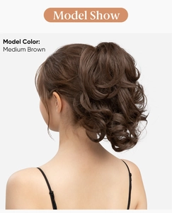 Rear view of model wearing a curly medium brown claw clip ponytail hair extension