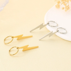 Detailed view of polished lightning bolt drop earrings in gold and silver finish