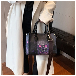 Detail of fashion skull tote bag with glowing purple eyes and adjustable shoulder strap