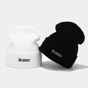Classic knitted beanies with Mommy embroidery in black and white minimalist style