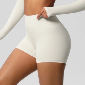 Detailed close-up of high-waist white yoga shorts showing the premium brushed fabric texture