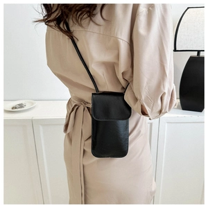 Back view of a model wearing a chic black leather small square crossbody phone bag