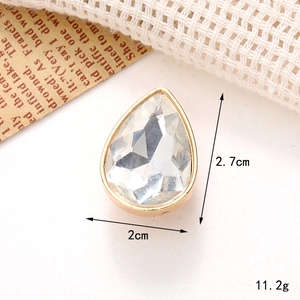 Detailed view of teardrop rhinestone charm in gold setting with size 2.7x2cm and 11.2g weight