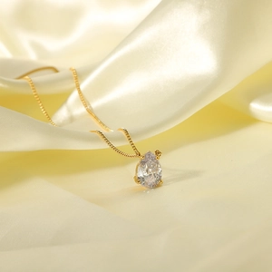 18k gold plated stainless steel necklace with teardrop white zircon on yellow silk fabric