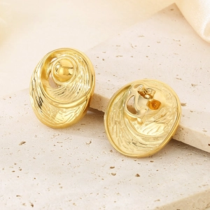 Macro shot of 18K gold plated vintage embossed oval studs with elegant bead details