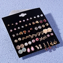 Detailed macro view of assorted sparkling stud earrings featuring crystals and gold finish