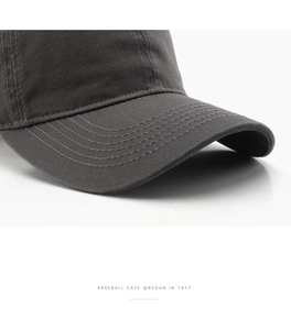 Close-up of charcoal grey cotton baseball cap with detailed six-row brim stitching