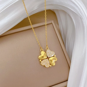 Detail of clover necklace with gold-plated heart petals and sparkling cubic zirconia inlay