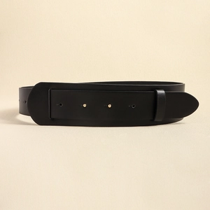 Detail of a minimalist black leather waist belt with two decorative gold round studs