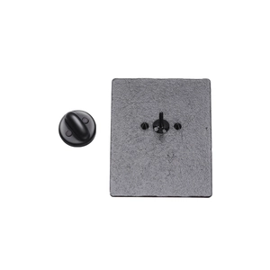Detail view showing black metal rectangular pin back with three pins and rubber clutch backings