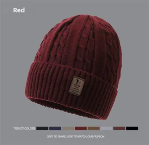 Detailed knit texture of a thick winter beanie with a leather logo and color options