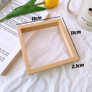 Detailed view of cream-colored accessory storage frame with 11x11x2.1cm dimensions