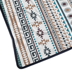 Close-up of flannel blanket showing Bohemian geometric patterns and soft fiber texture