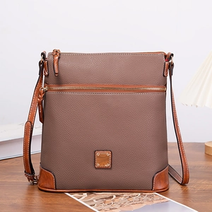 Detail of taupe lychee grain leather crossbody bag with metal logo and gold zipper hardware