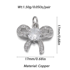 Detail of copper bow pendant with clear round gemstone and sparkling side stones