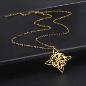 Golden stainless steel Celtic Witch Knot pendant necklace on black leather surface