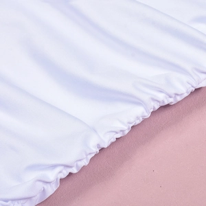 Detail of white dress with elastic scalloped edges and textured fabric weave