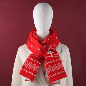 Detailed knit pattern showing festive snowflakes and trees on a red Christmas scarf