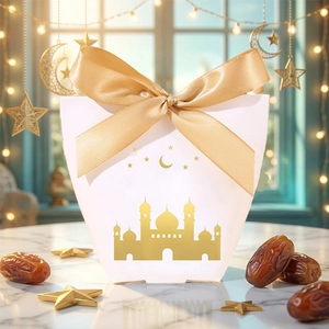 Detailed view of white gift box with gold mosque pattern and elegant ribbon bow