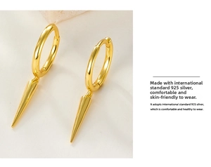 Macro shot of gold S925 sterling silver spike hoop earrings showing hallmark detail