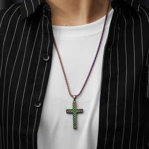 Detail of a rainbow stainless steel cross pendant on a matching beaded chain worn by a male model