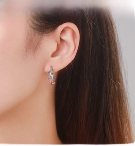 Close-up of S925 silver hoop earrings with vibrant colorful cubic zirconia gemstones